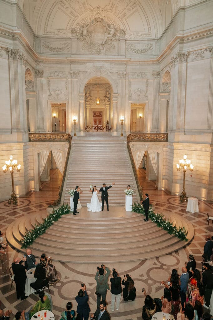 Bride and groom making their grand entrance at San Francisco City Hall