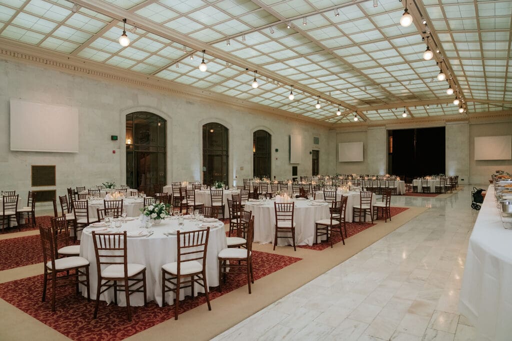 Wedding dinner tables set in the North Light Court at SF City Hall