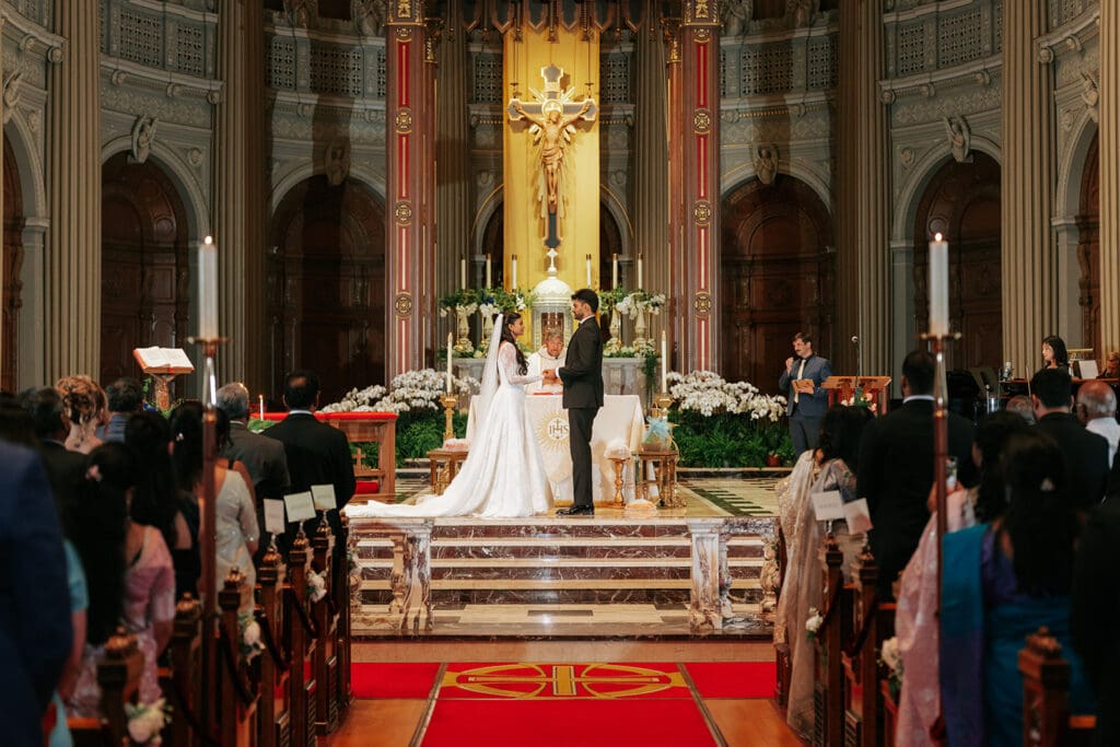 Bride and groom at the altar during their St. Ignatius Church wedding ceremony