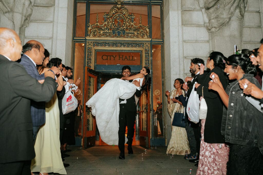 Newlyweds bubble grand exit at San Francisco City Hall at night